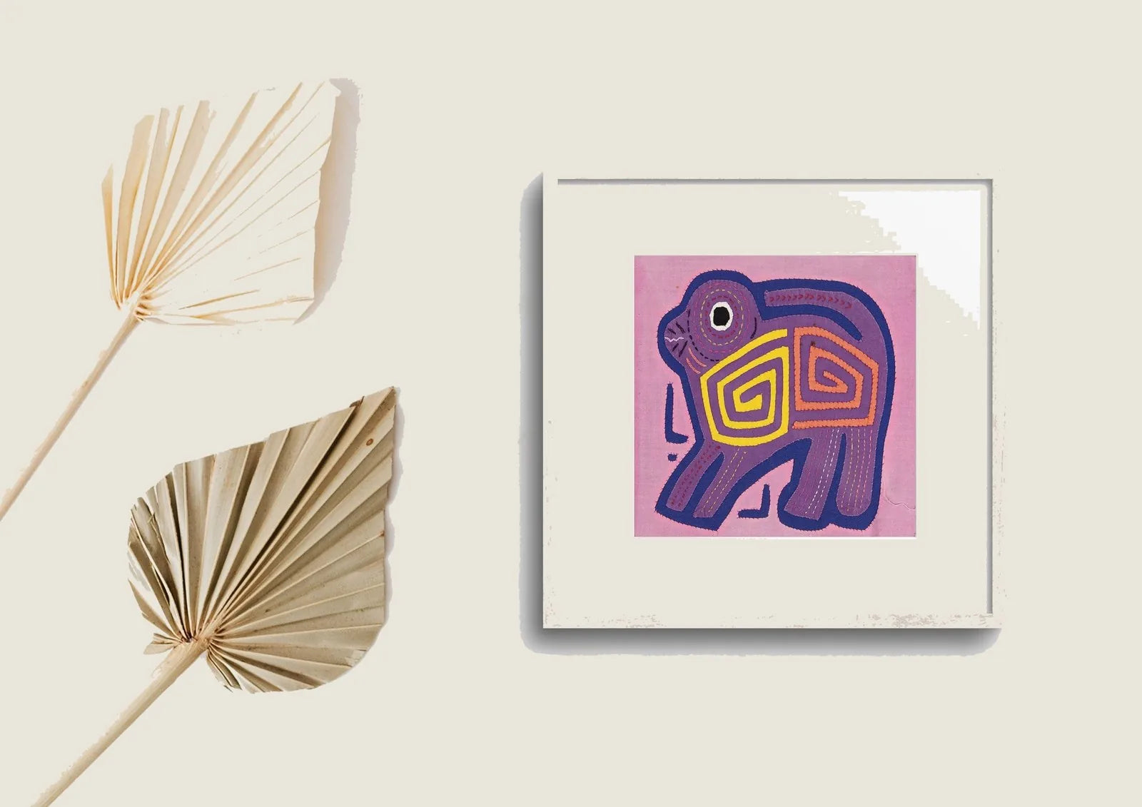 Hand-stitched pink and purple Molita of a puppy dog with vibrant geometric patterns in the design, framed for display.