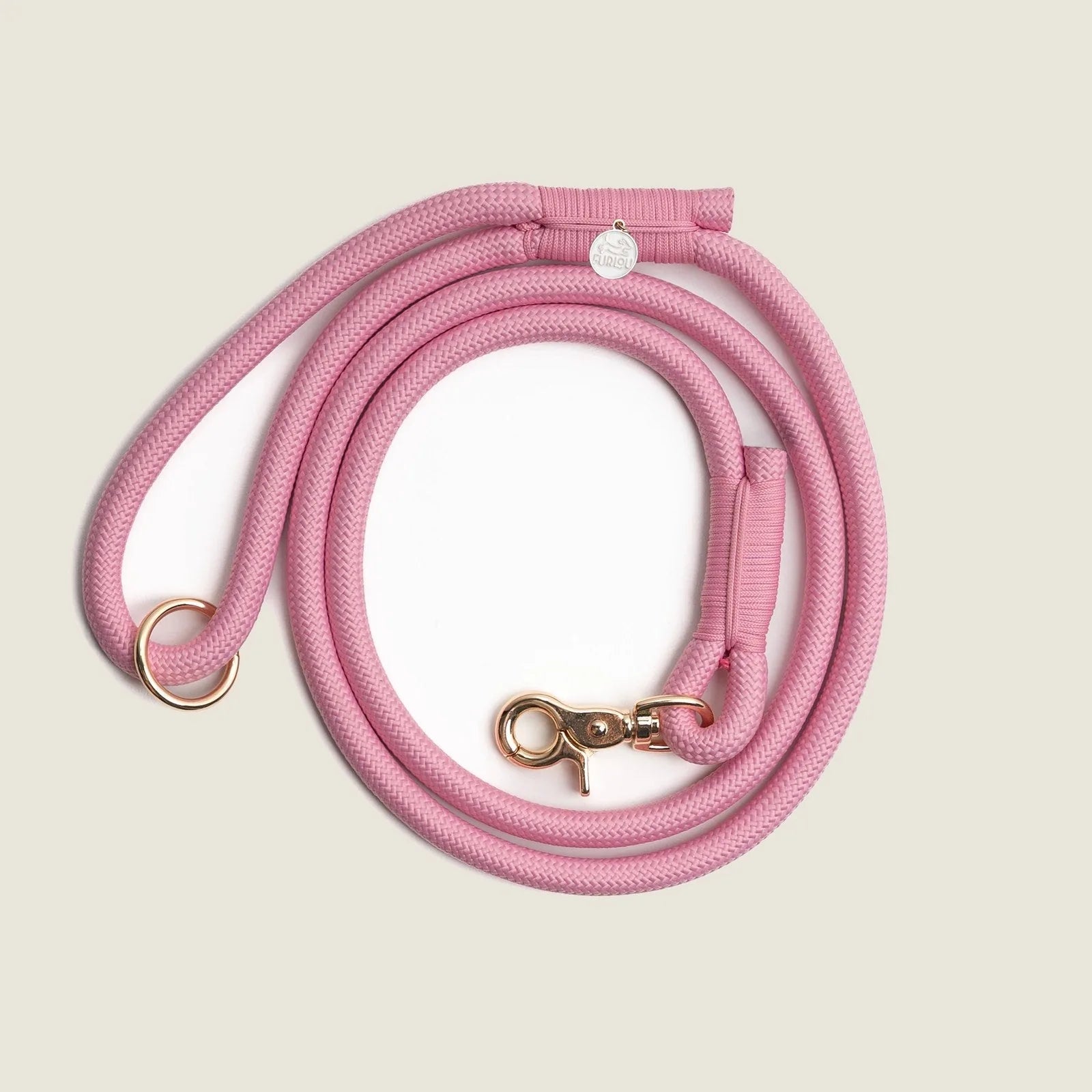 Durable pink braided rope leash with reinforced stitching and gold O-ring, perfect for daily dog walks.