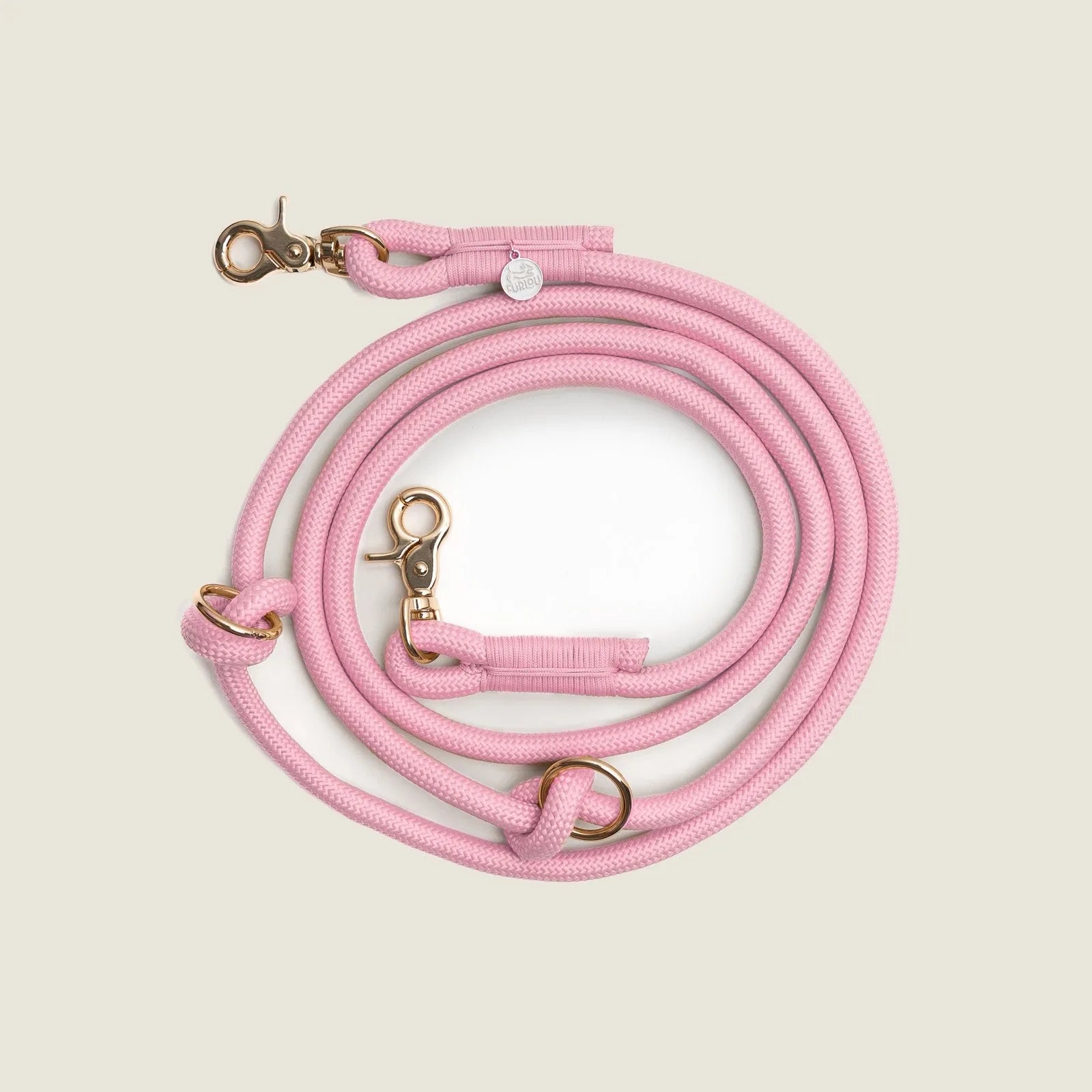 Braided pink hands-free leash by FURLOU, featuring gold clips and rings for versatile use. Perfect for walking your dog.