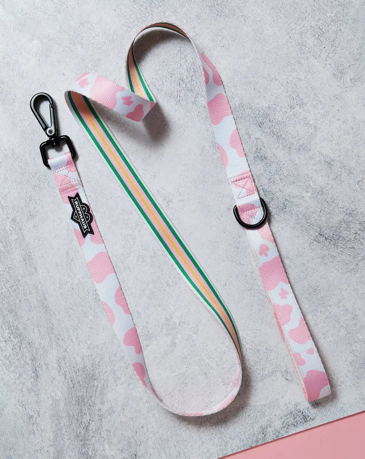 Pink Moo'd dog leash featuring a playful pink and white pattern, with a neoprene-lined handle and a swivel snap clasp.