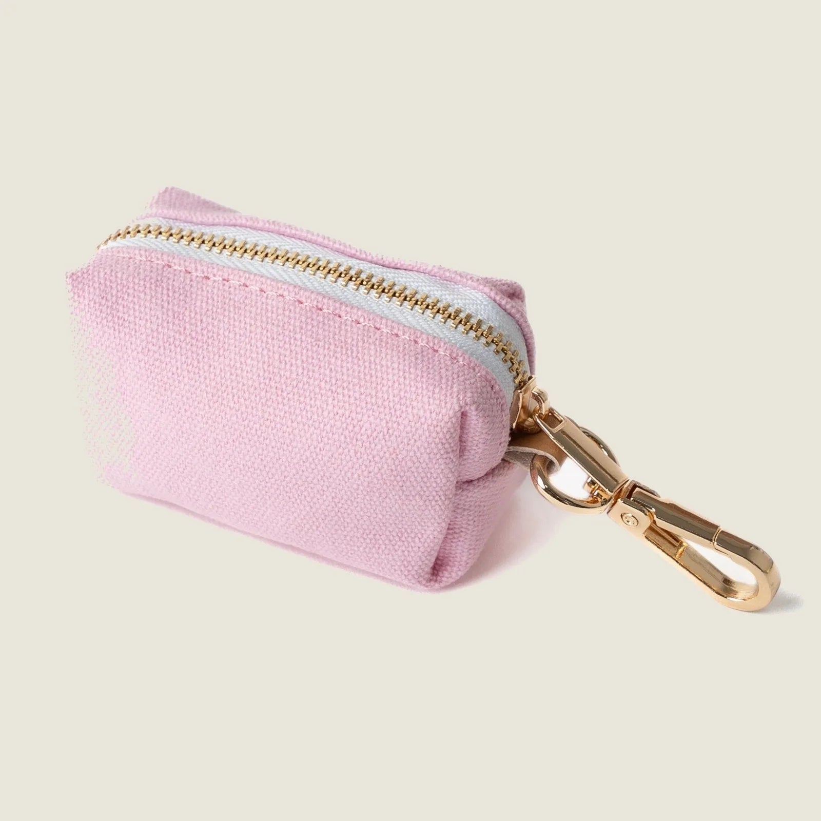 Compact pink poop bag holder by FURLOU, featuring a gold zipper and clip for easy attachment to leashes.
