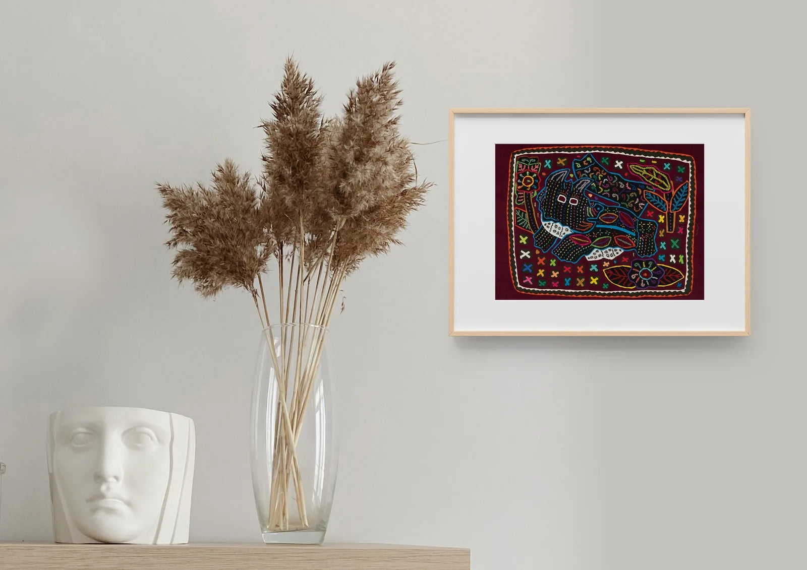 Hand-stitched Mola featuring a playful terrier puppy design in vibrant colors on a dark background.