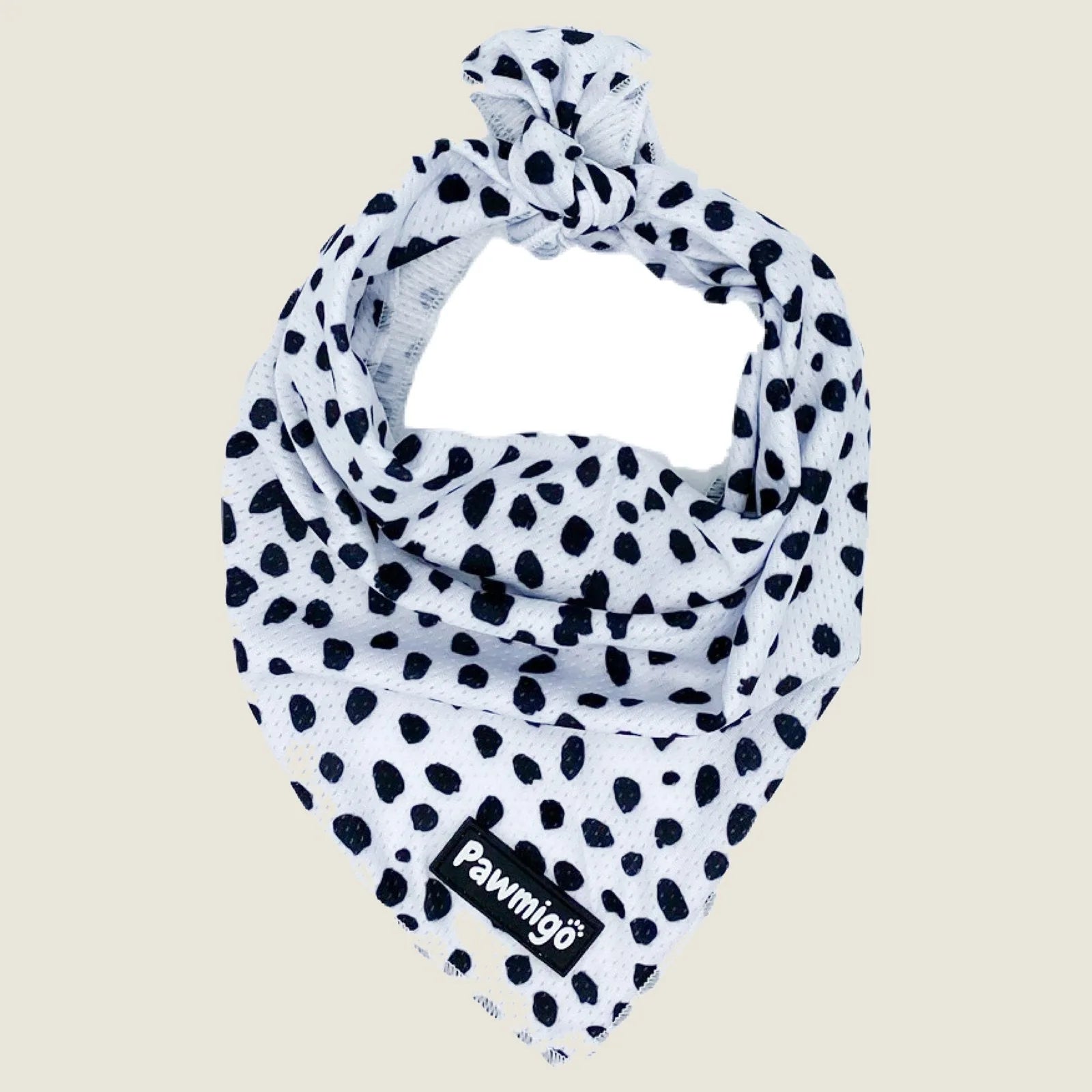 Polka dot cooling bandana in white with black spots, made from breathable mesh fabric for dog comfort on warm days.