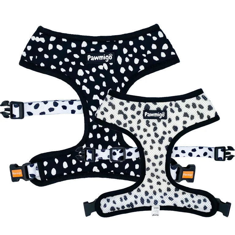Reversible black and white polka dot harness by Pawmigo, featuring plush padding and adjustable straps.