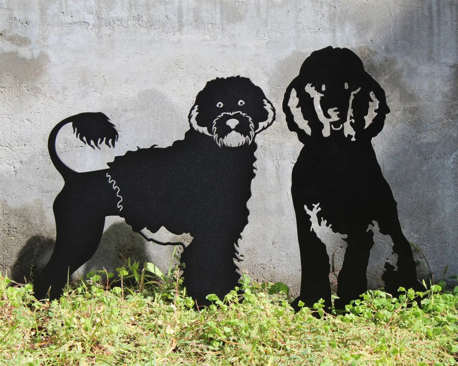 Black metal dog silhouettes of two poodles, featuring playful designs, perfect for outdoor garden decor.
