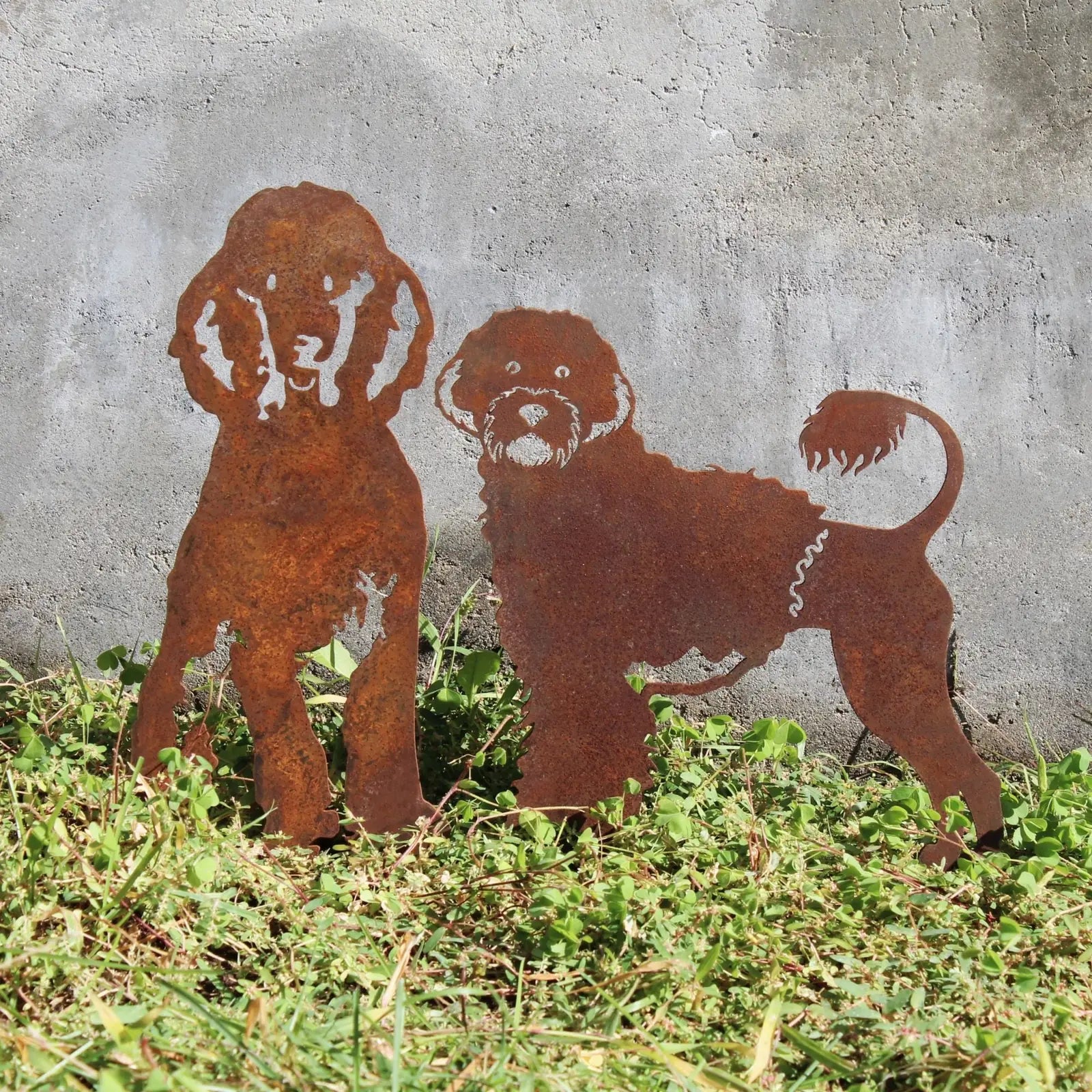 Rusty metal silhouette of two Portuguese Water Dogs standing on grass, showcasing detailed cut-outs and natural patina.