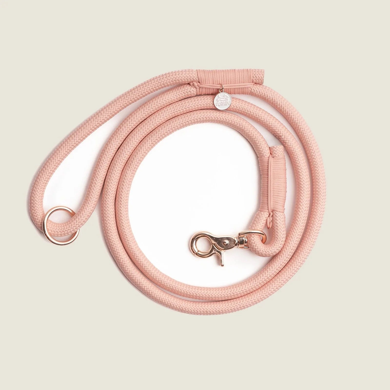 Powder rose braided nylon dog leash with a gold clasp and O-ring, designed for strength and comfort during walks.