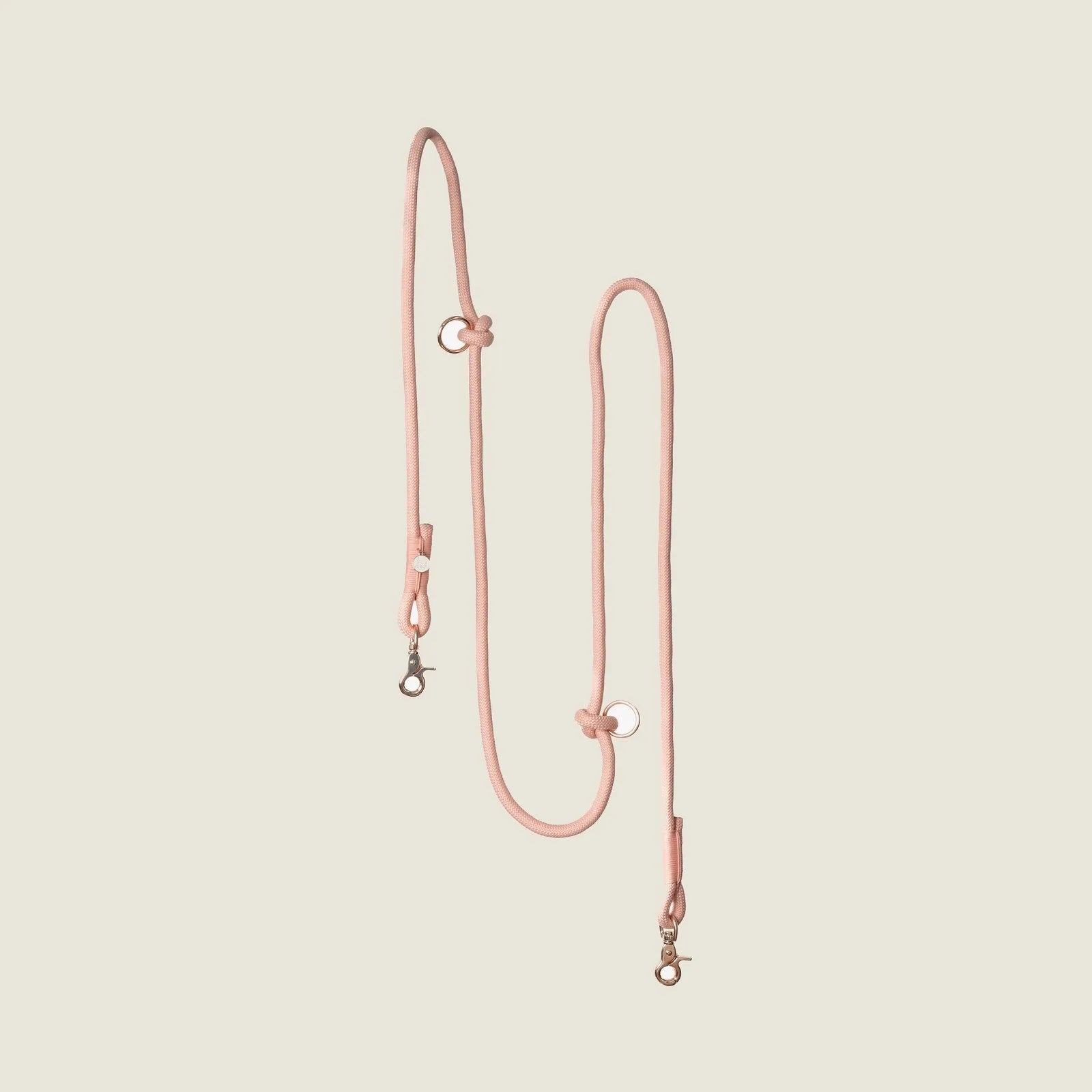 Powder rose hands-free braided leash with adjustable design and clips, perfect for walking your dog comfortably.