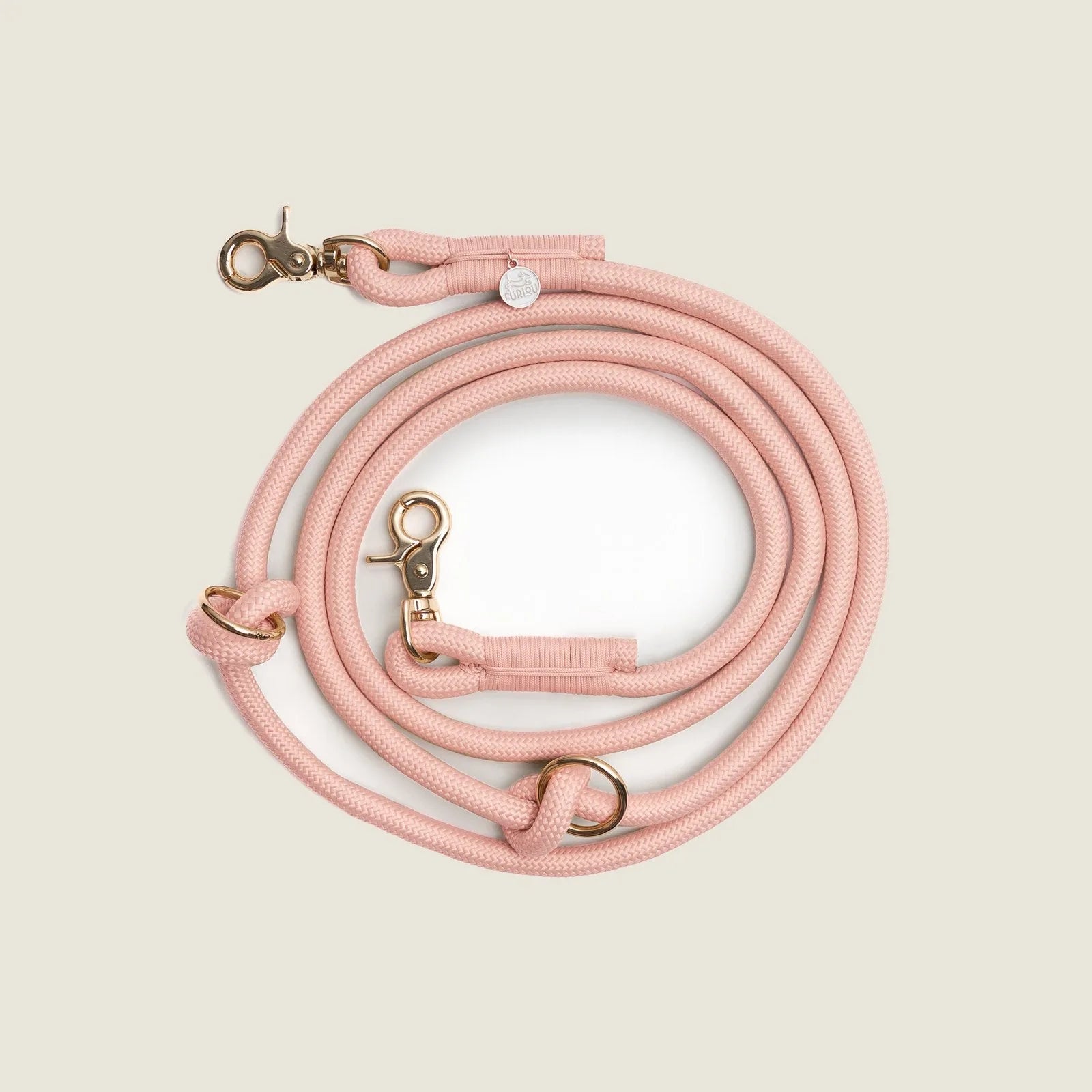 Powder rose braided leash with gold hardware, designed for hands-free use and everyday dog walks.