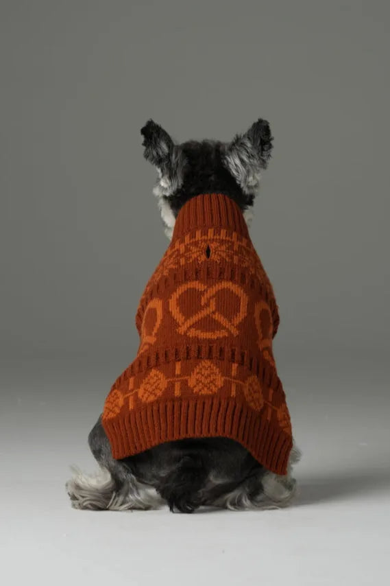 Toffee orange pet sweater with pretzel pattern, featuring a high collar and soft knit fabric, on a small dog.