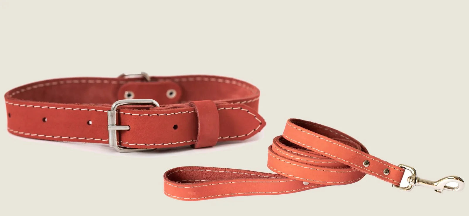 Soft coral leather dog collar and leash set with white stitching, showcasing durable materials for stylish daily walks.