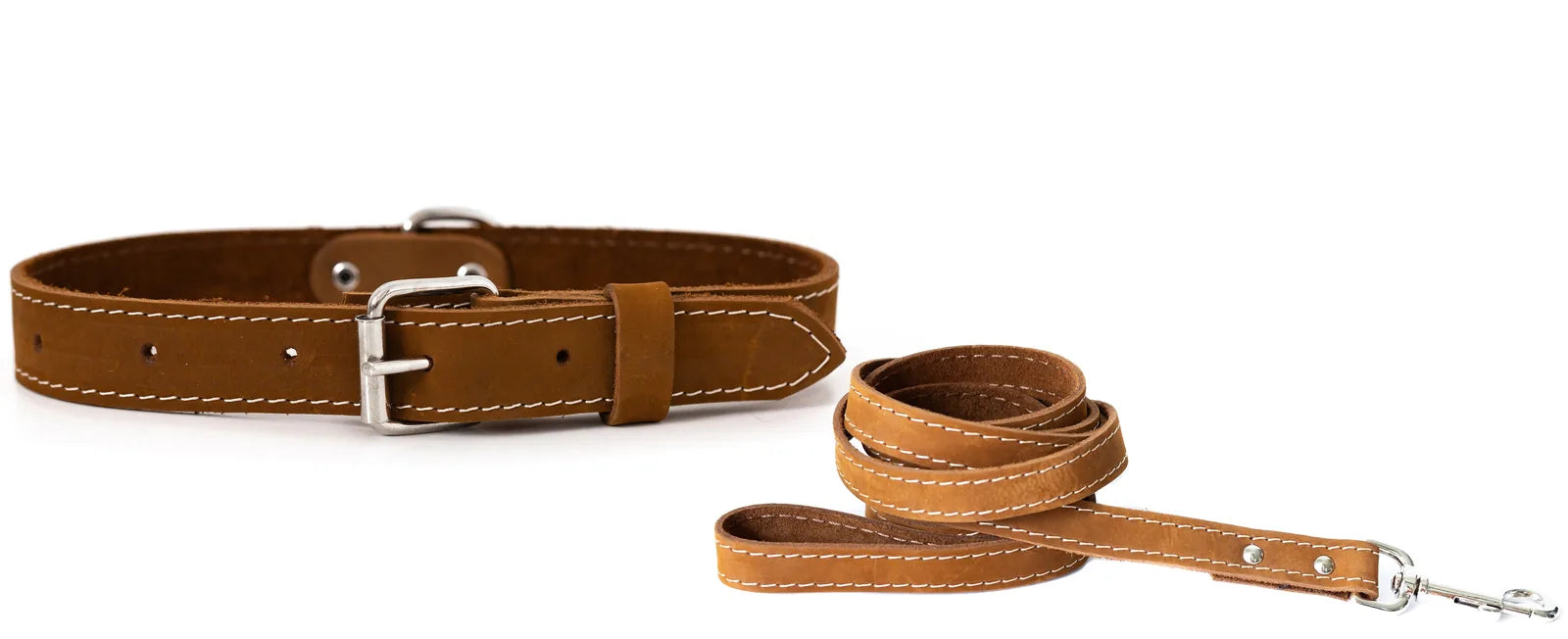 Soft tan leather dog collar and leash set with white stitching, featuring a sturdy metal buckle and clip.
