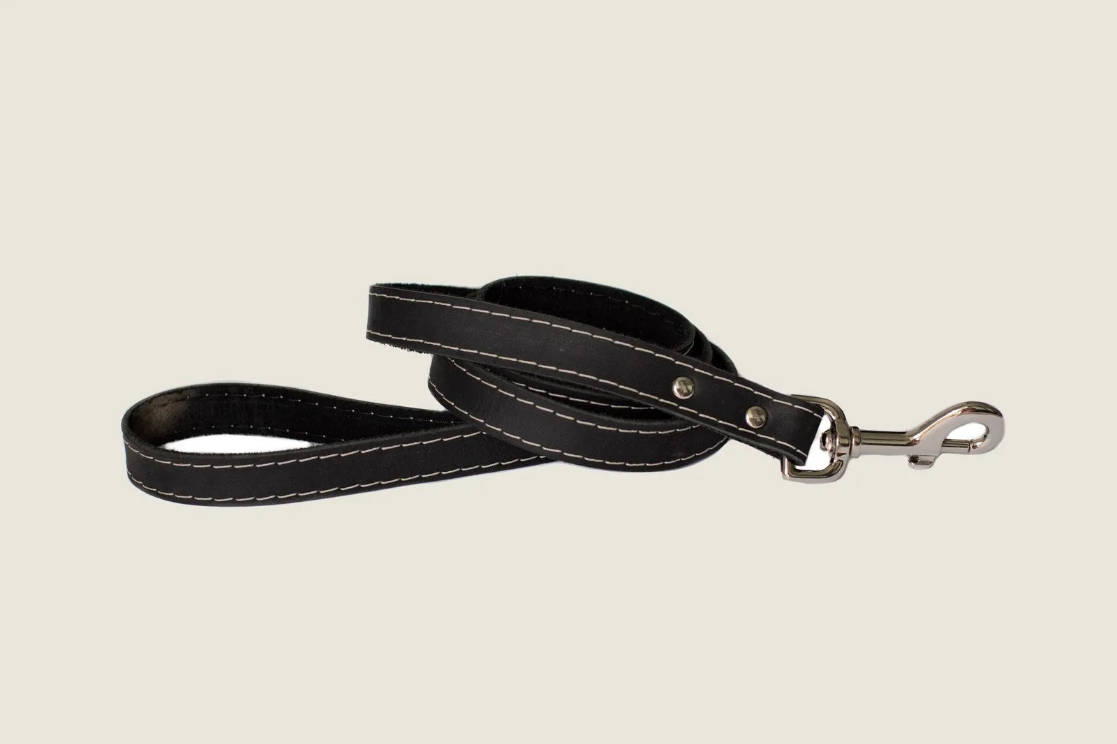 Midnight black leather dog leash with white stitching and a metal clasp, showcasing a sleek, durable design for walks.
