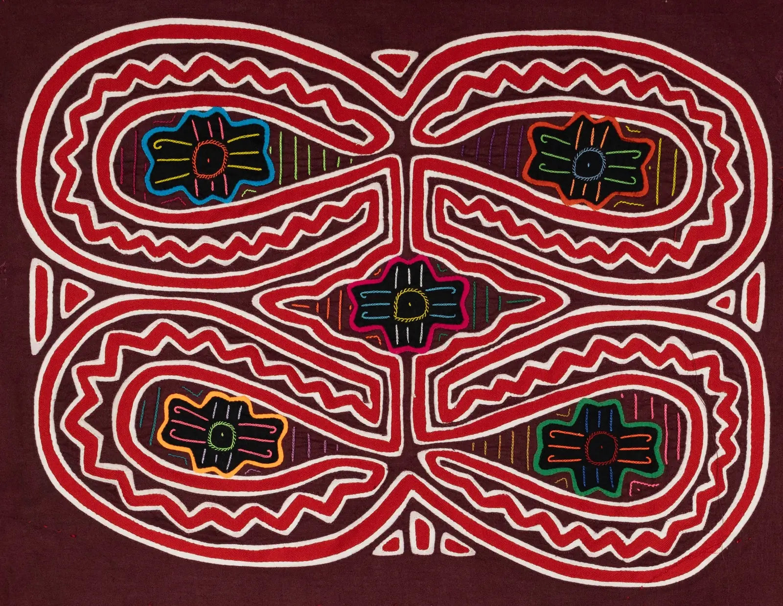 Colorful hand-stitched Mola featuring intricate geometric patterns on a rich maroon background by TraderBrock.