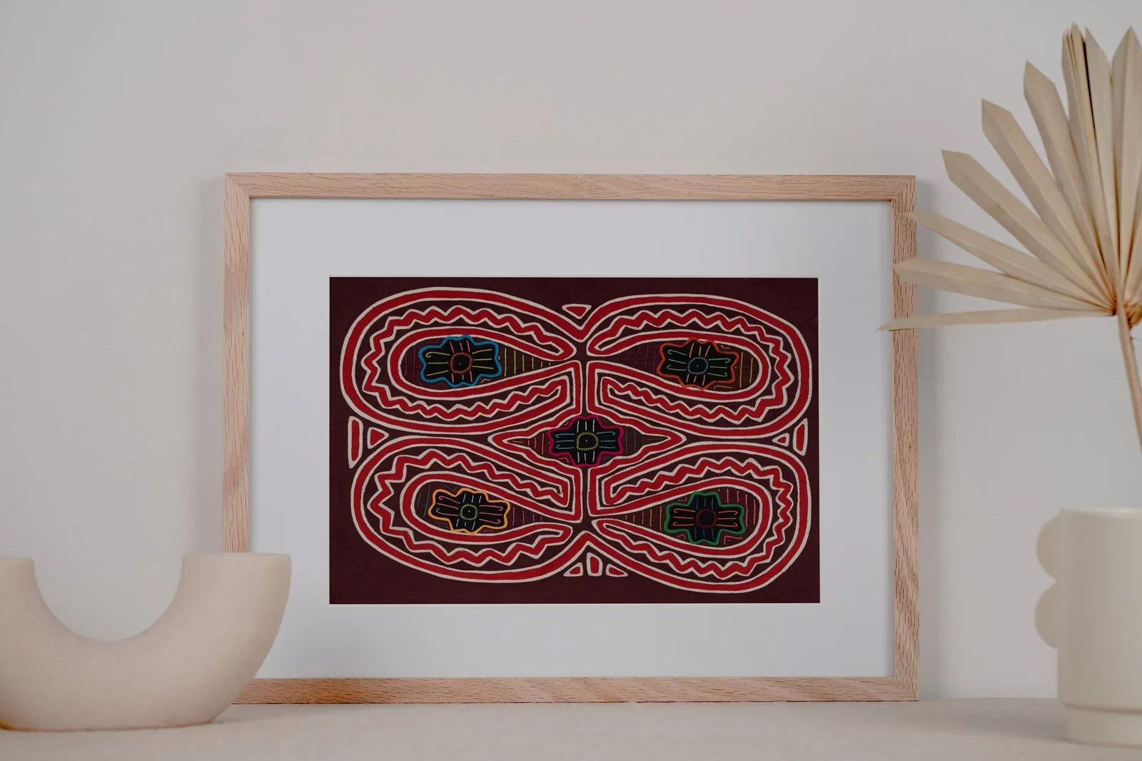 Pudgy Cheek Bull Dog Mola tapestry featuring vibrant geometric patterns on a dark background, framed and displayed decorat...
