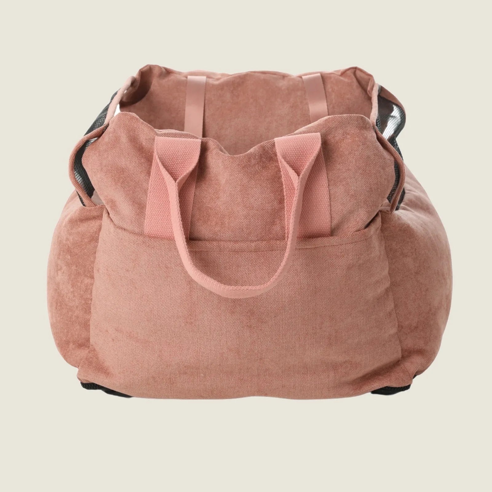 Pink Puff Guard Dog Car Seat with soft fabric, sturdy handles, and mesh sides for ventilation and comfort during travel.