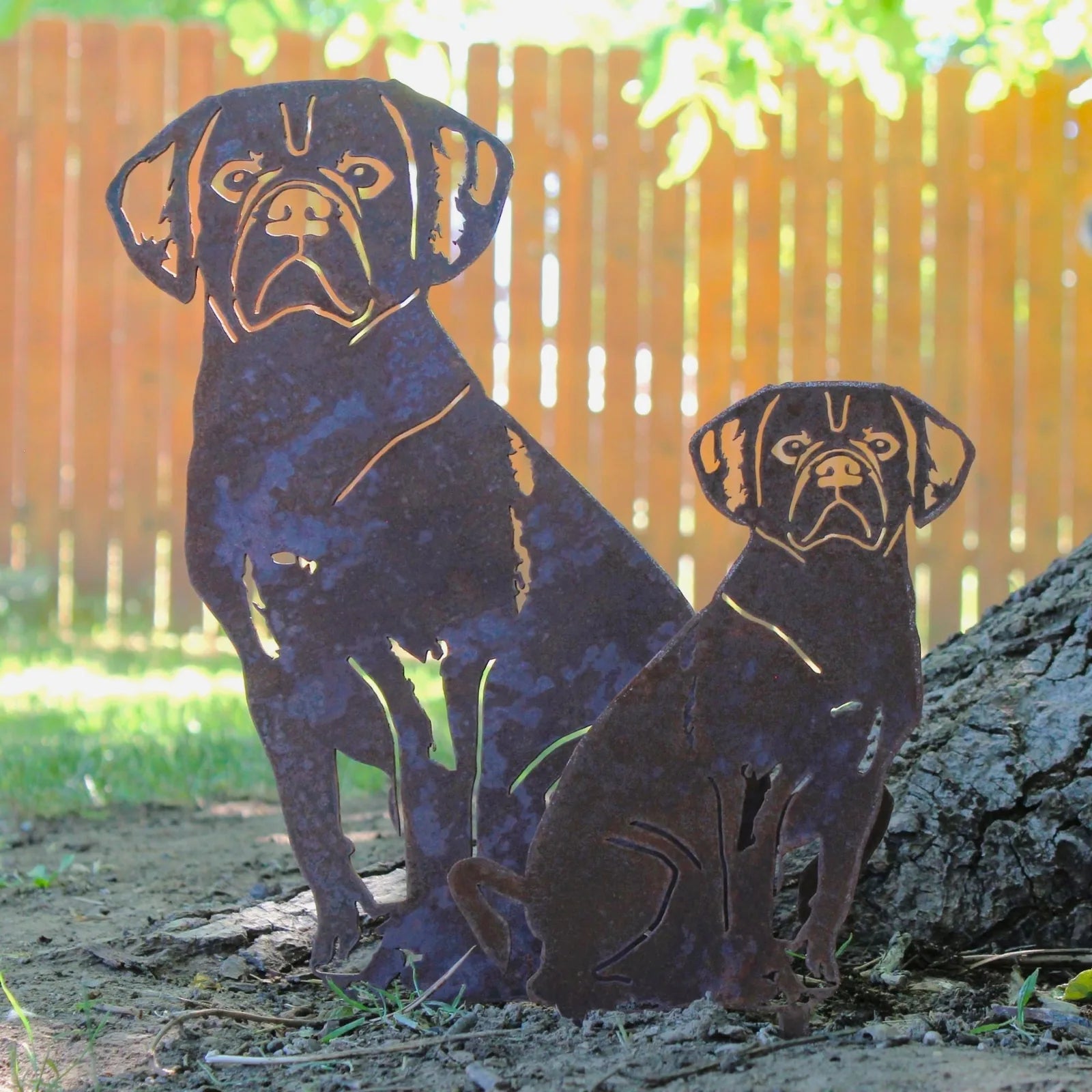 Puggle metal silhouette in rusted corten steel, showcasing a large and small dog design in a garden setting.