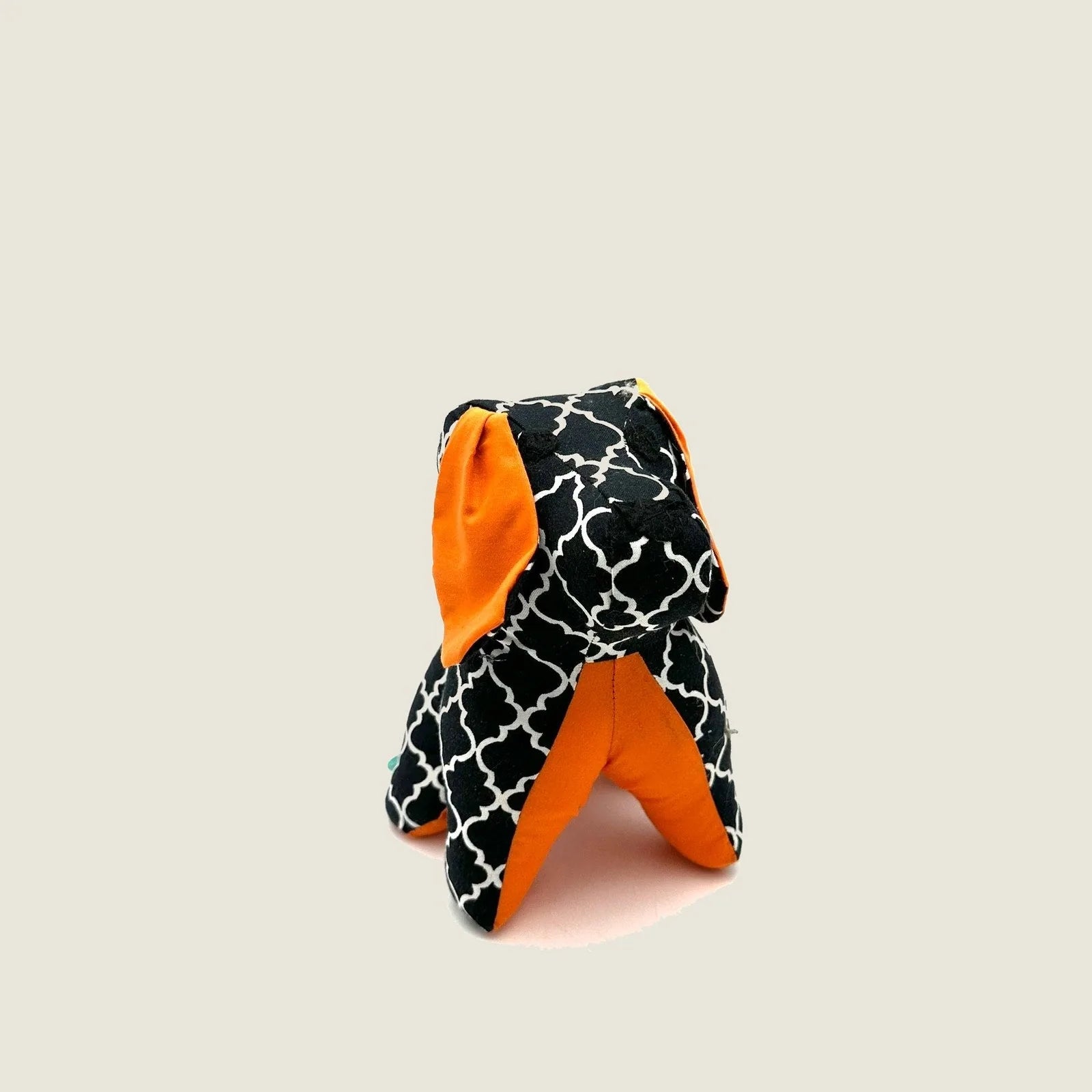 Black and orange decorative puppy dog figurine with a patterned design, adding charm to any space.