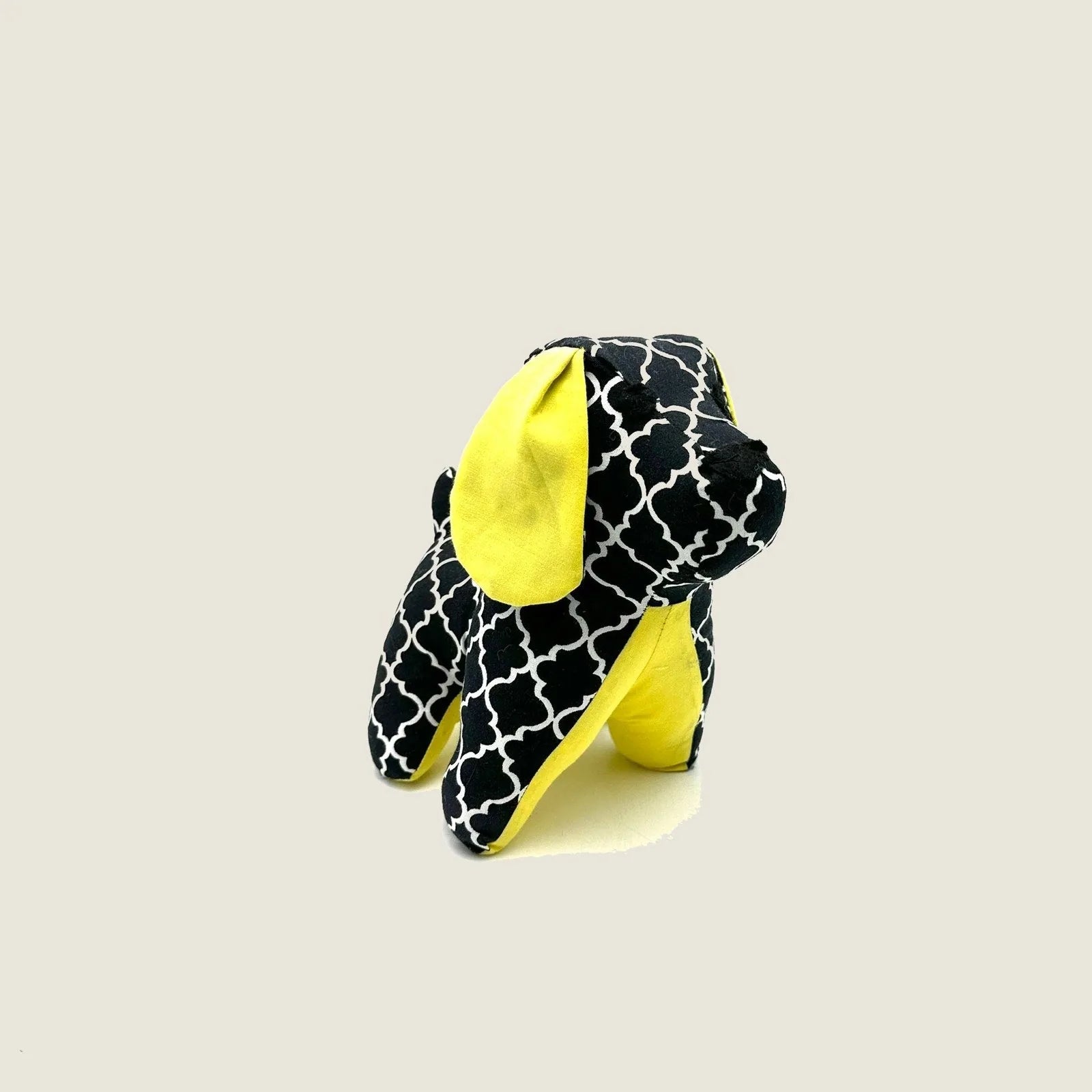 Decorative black and yellow puppy figurine with a playful geometric pattern, about 8 inches tall.