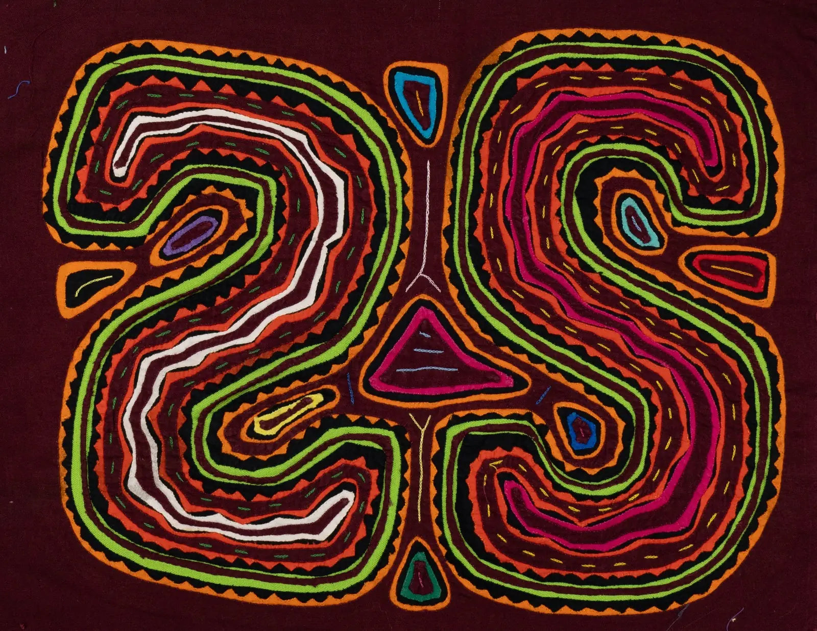 Colorful geometric patterns in bold reds, greens, and pinks on a deep maroon tapestry, showcasing traditional Mola textile...
