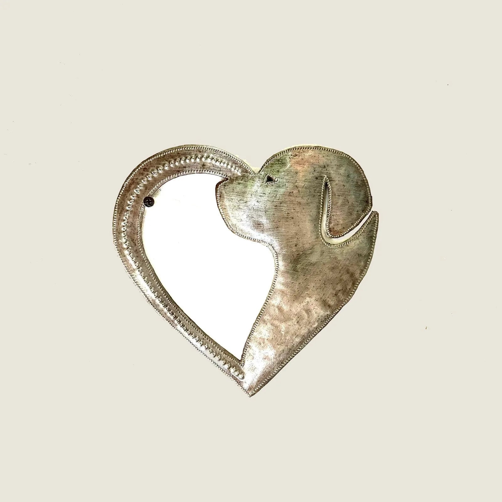Handcrafted metal art of a dog's silhouette within a heart shape, made from recycled steel, showcasing a rustic finish.