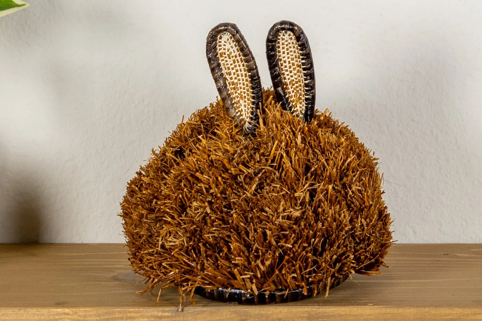 Handwoven puppy dog mask in brown with textured fur and curved ears, crafted by Indigenous artisans from Panama.