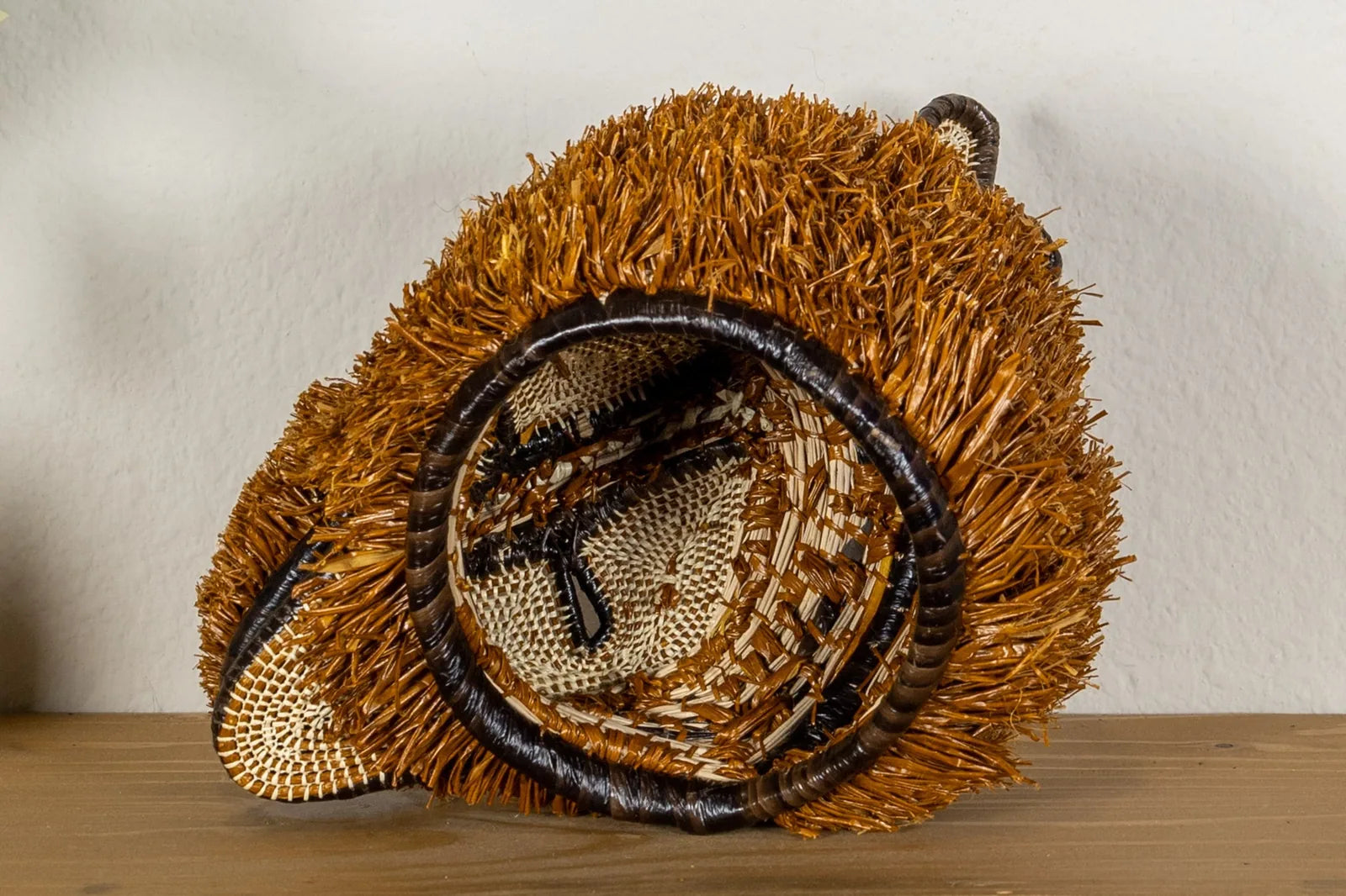 Handwoven Puppy Dog Mask featuring natural brown tones and textured designs, crafted by Indigenous artisans in Panama.