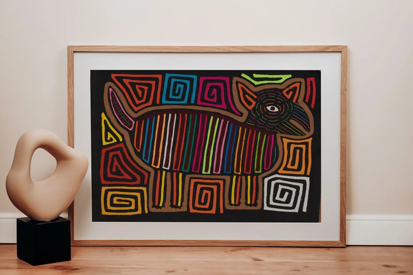 Colorful hand-stitched Mola featuring a stylized dog design with vibrant patterns and intricate shapes.