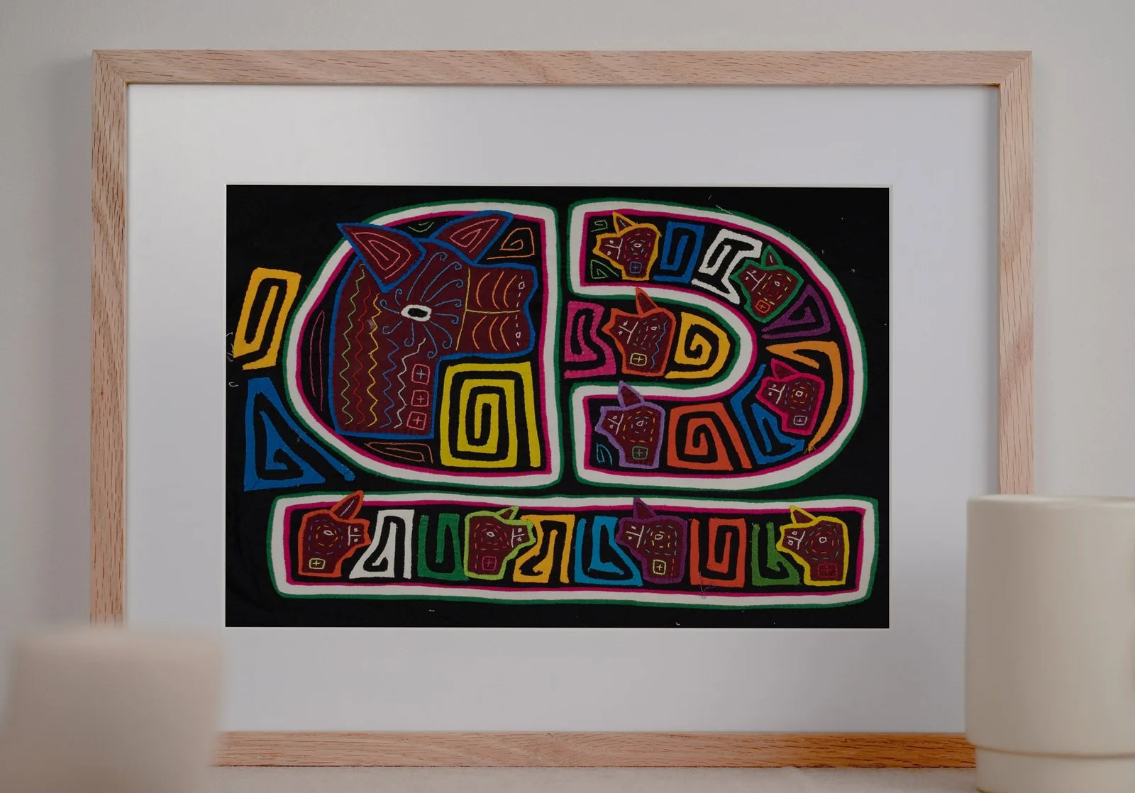 Hand-stitched Mola featuring vibrant geometric designs of dogs on a black background, showcasing traditional Panama textil...