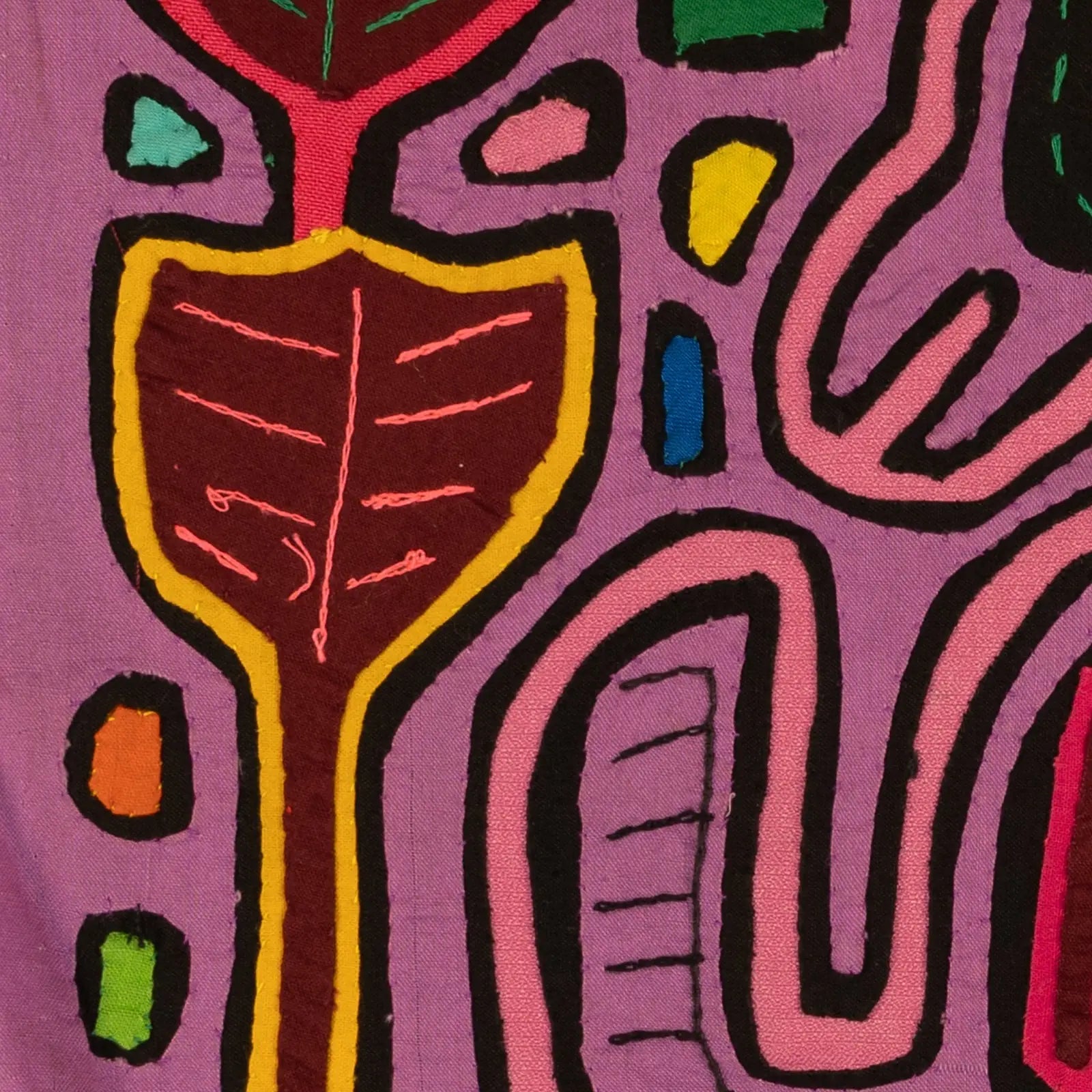 Hand-stitched purple textile featuring colorful leaf designs in red, green, and yellow, showcasing traditional Mola art.