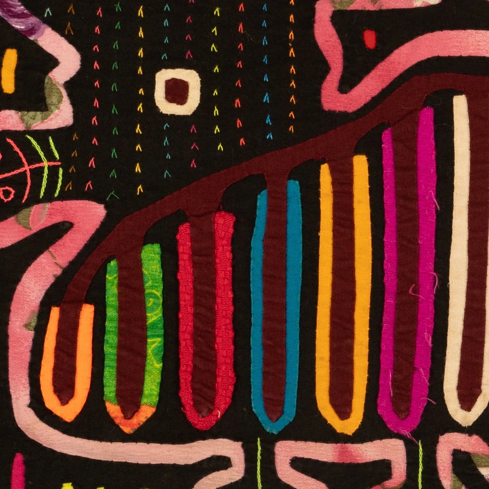 Hand-stitched purple and multicolored textile design featuring bold shapes and patterns on a black background.