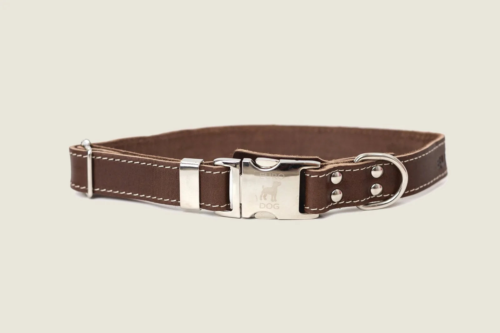 Brown leather dog collar with silver buckle and hardware, featuring white stitching detail for a stylish finish.