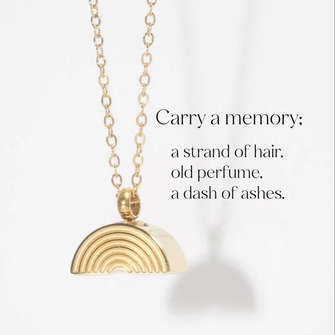 Gold rainbow bridge necklace pendant on a delicate chain, designed for holding pet ashes or mementos.