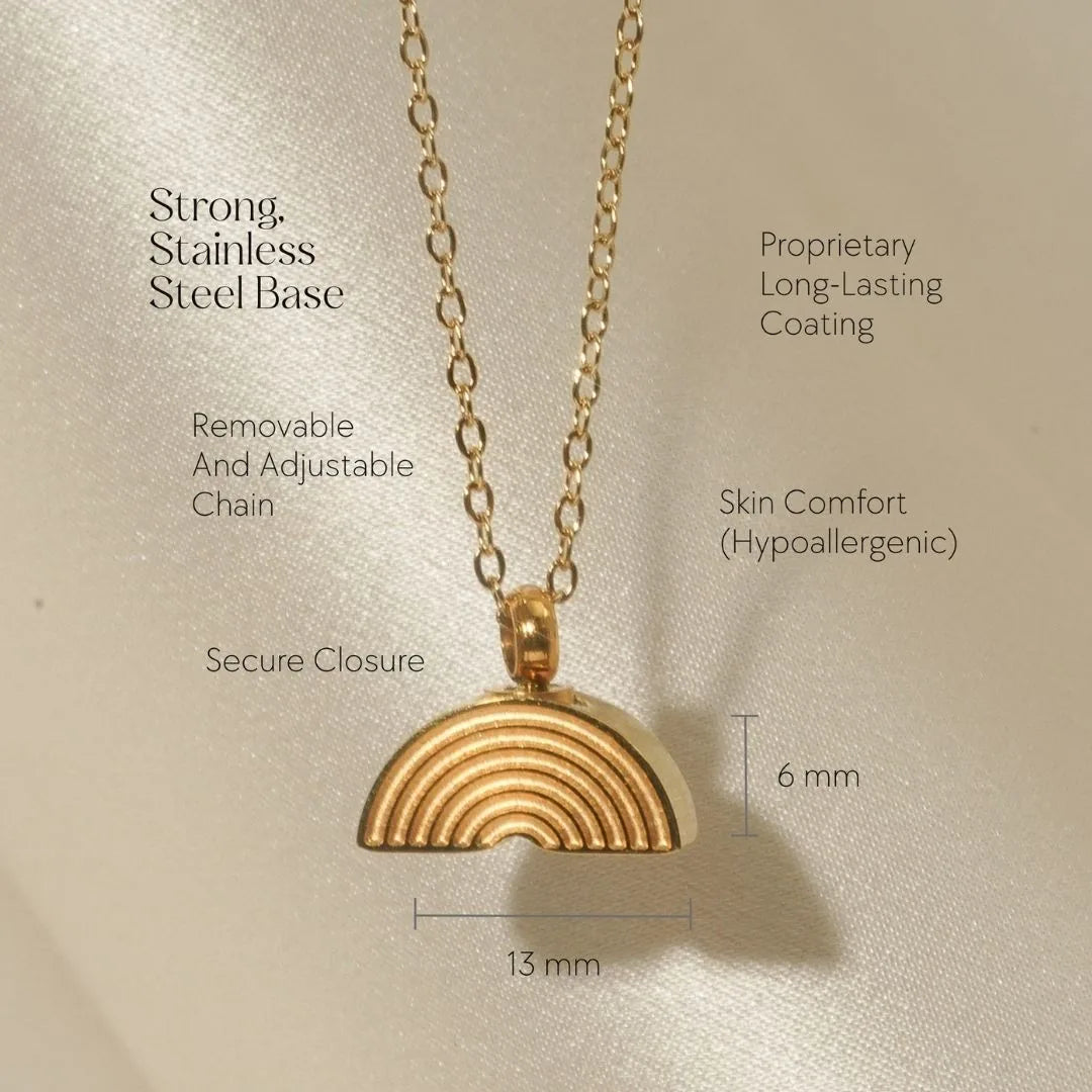 Gold Rainbow Bridge cremation necklace with a removable chain, featuring a textured rainbow design on a hypoallergenic base.
