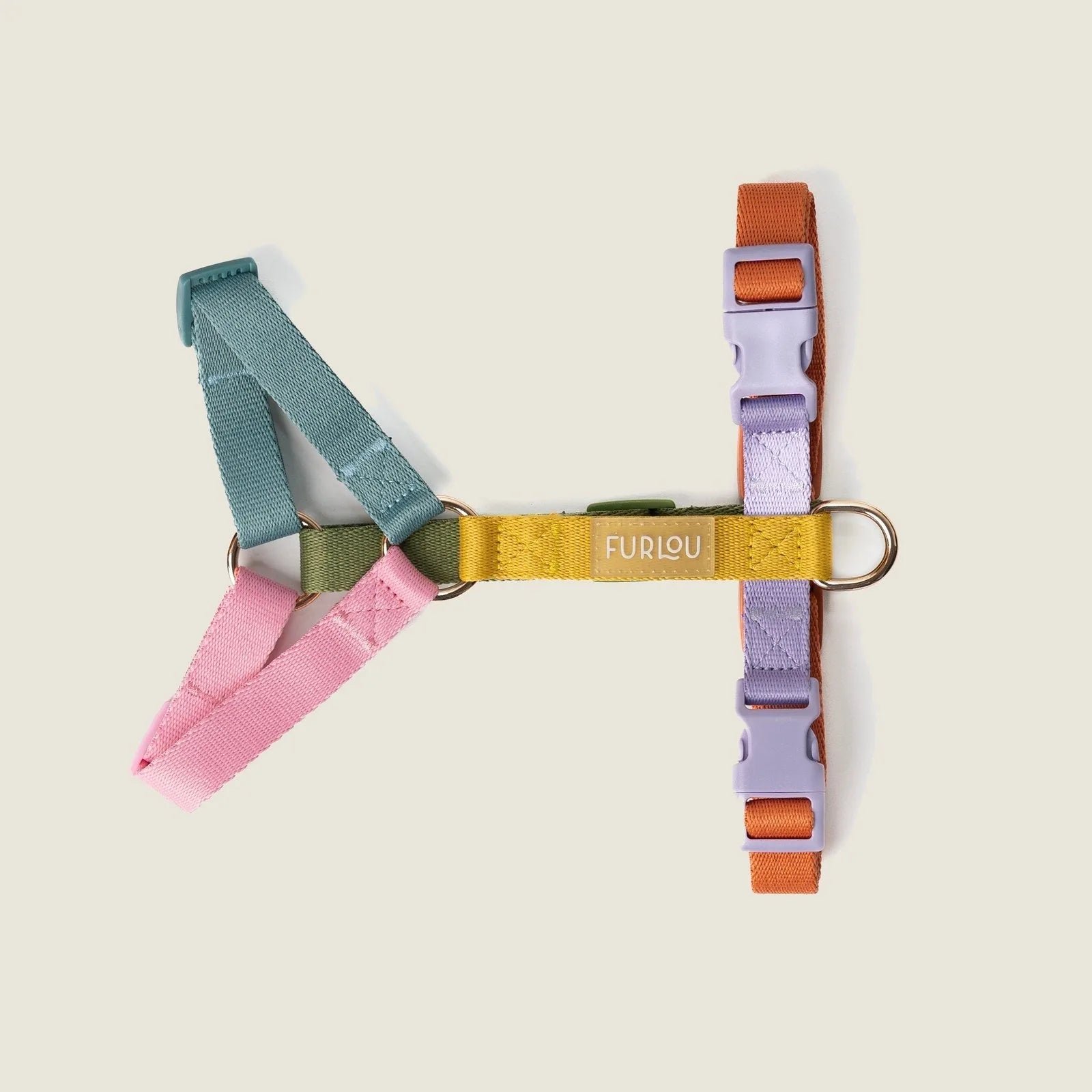 Colorful FURLOU Rainbow Dog Harness with multiple adjustable straps in pink, teal, green, and orange.