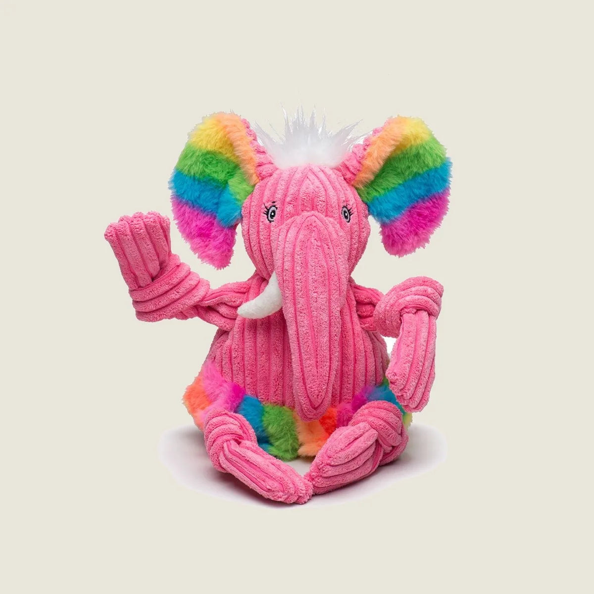 Colorful pink elephant plush toy with rainbow fur accents and knotted limbs, designed for interactive play and cuddling.