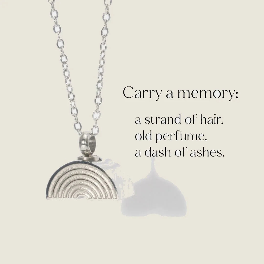 Silver rainbow pendant necklace designed for memorializing loved ones, featuring a delicate chain and intricate details.