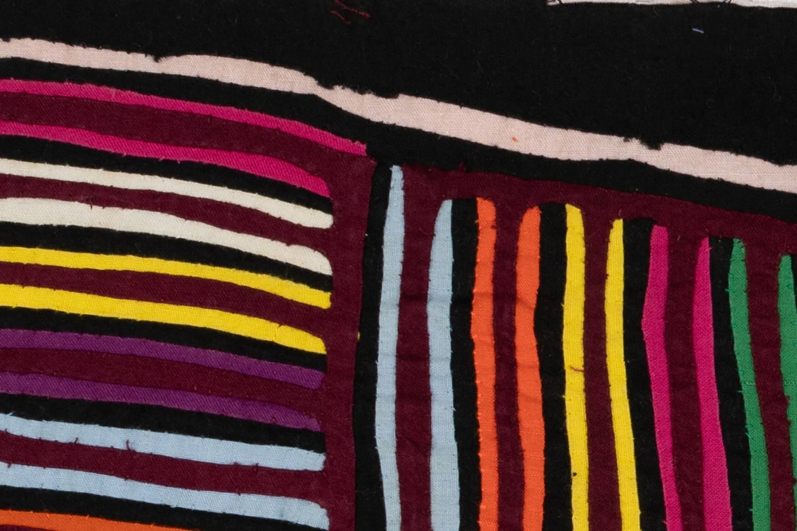 Colorful stripes in various shades, including purple, yellow, and black, showcasing intricate textile craftsmanship.