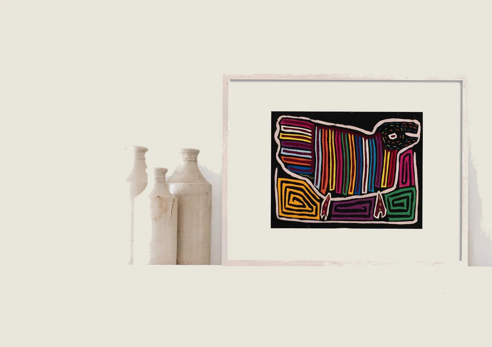 Colorful textile artwork featuring a stylized dog design with geometric patterns on a black background.