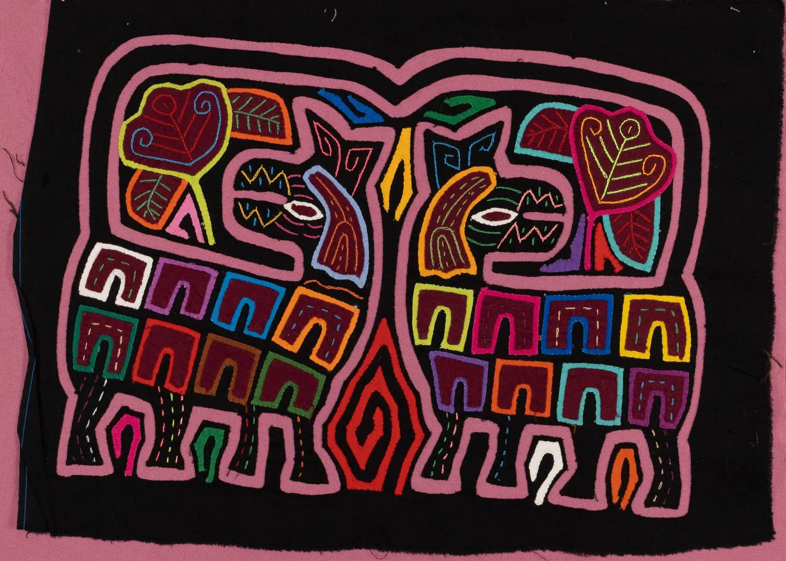 Colorful hand-stitched Mola featuring geometric animal designs on a black background, showcasing traditional Panama textil...