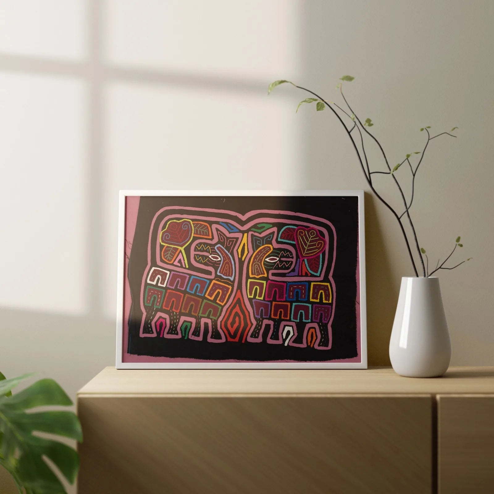 Colorful hand-stitched Mola tapestry featuring geometric elephant designs on a black background, showcasing indigenous art.