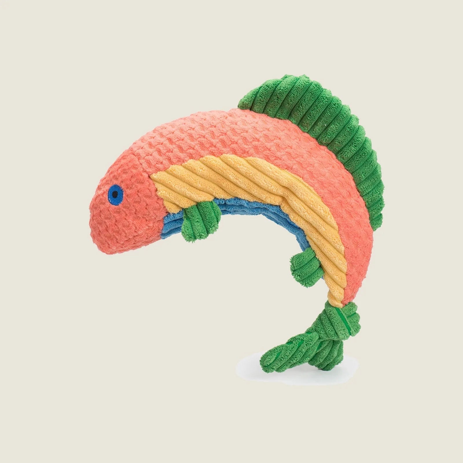 Colorful plush trout-shaped dog toy featuring a textured design in pink, blue, yellow, and green with knotted fins.