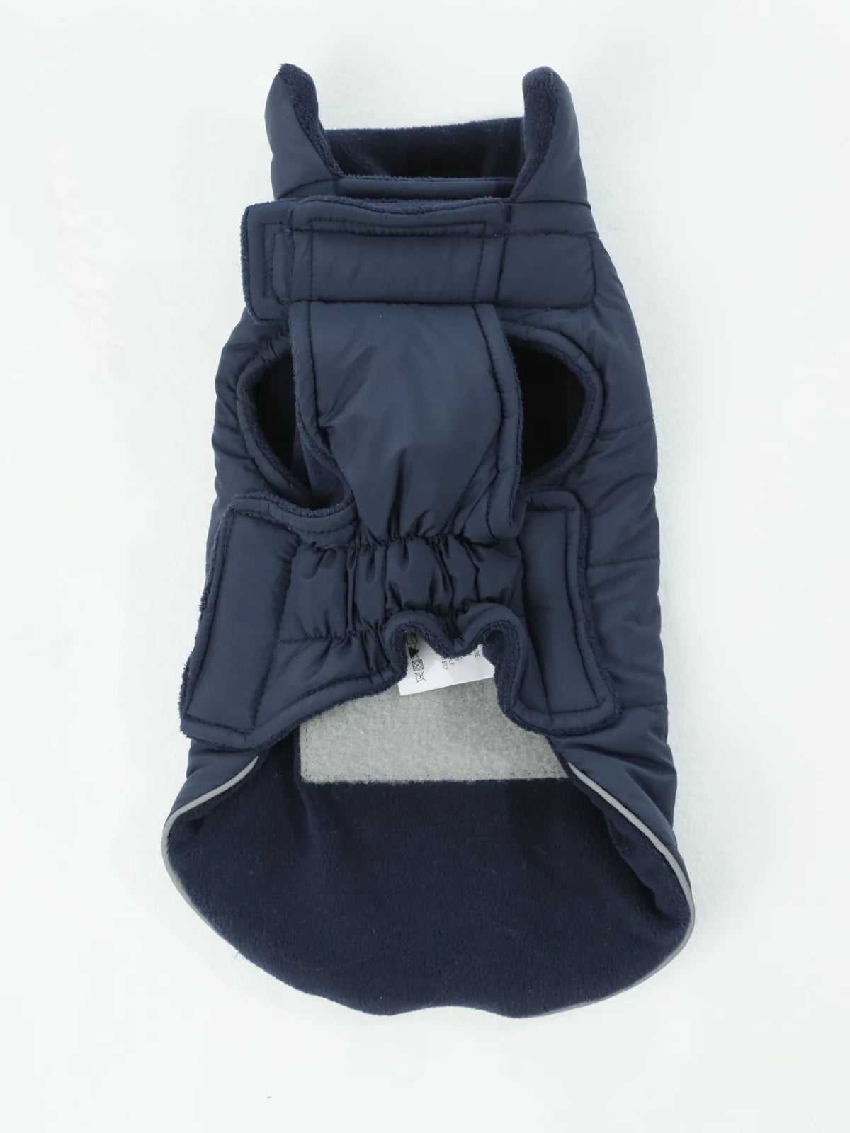 Reversible blue dog vest jacket with thick polar fleece lining and adjustable Velcro closures for warmth and comfort.