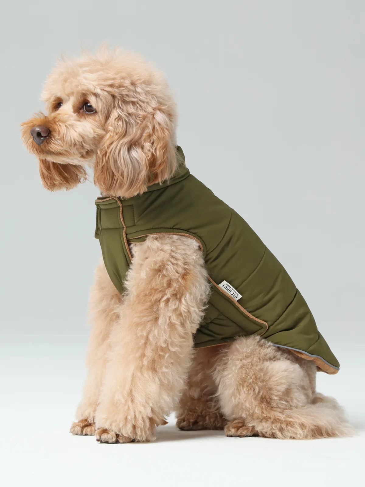 Reversible dog vest jacket in green, featuring a plush fleece lining and adjustable Velcro for a cozy fit.