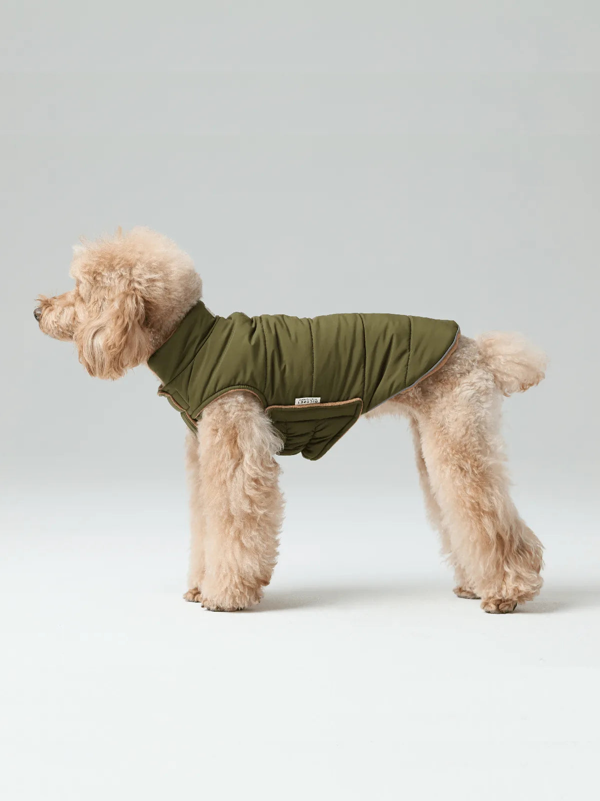 Reversible green dog vest jacket with thick fleece lining, designed for comfort in cold weather and outdoor adventures.
