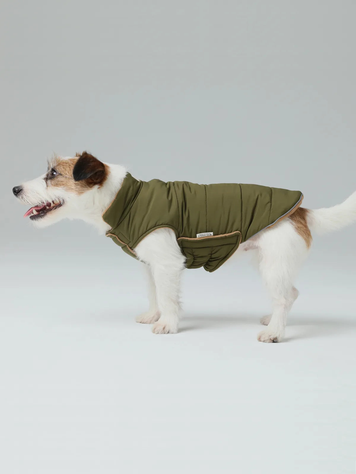Reversible dog vest jacket in green, featuring a warm polar fleece lining and adjustable Velcro closures for a snug fit.