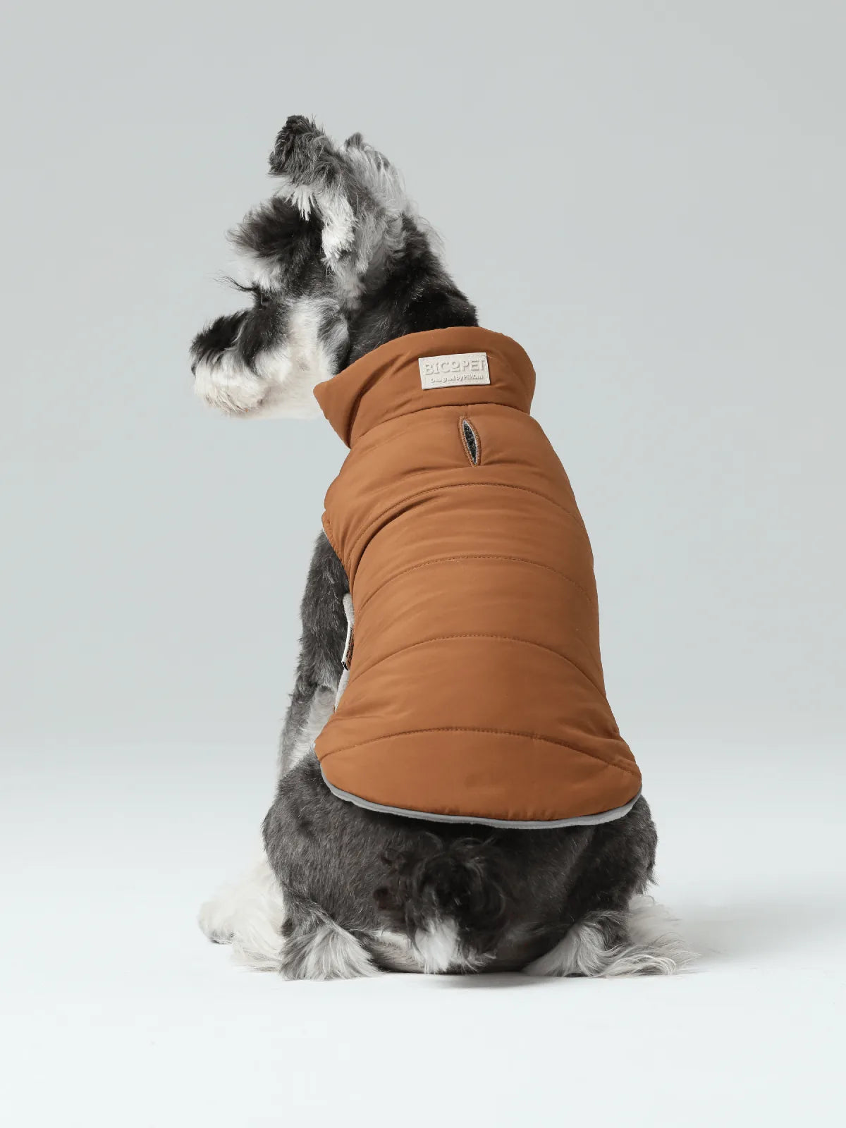 Reversible dog vest jacket in orange and grey, with a comfortable fit and reflective details for safety.