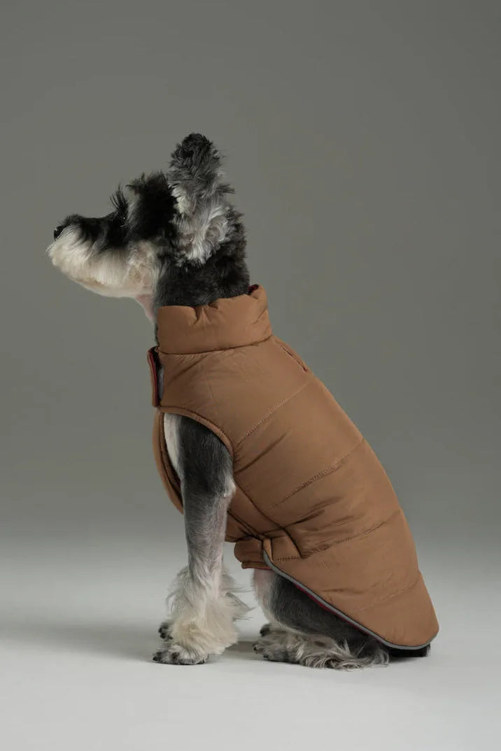 Brown reversible dog vest jacket with a high collar and puffy design, perfect for outdoor comfort and warmth.