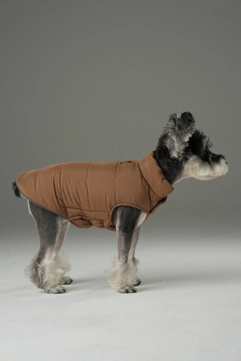 Reversible dog vest jacket in warm brown, featuring a quilted design and a snug fit for outdoor comfort.
