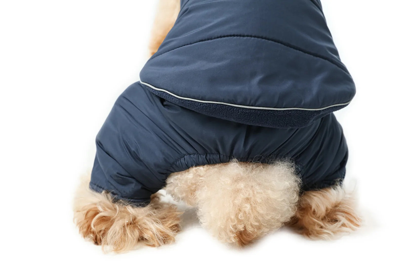Reversible red dog vest jacket with thick fleece lining, shown on a fluffy dog, ideal for cold and rainy weather.